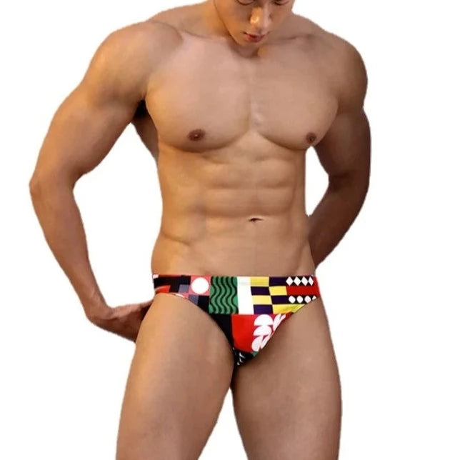 a sexy gay man in Colorful Patchwork Swim Briefs - pridevoyageshop.com - gay men’s underwear and swimwear