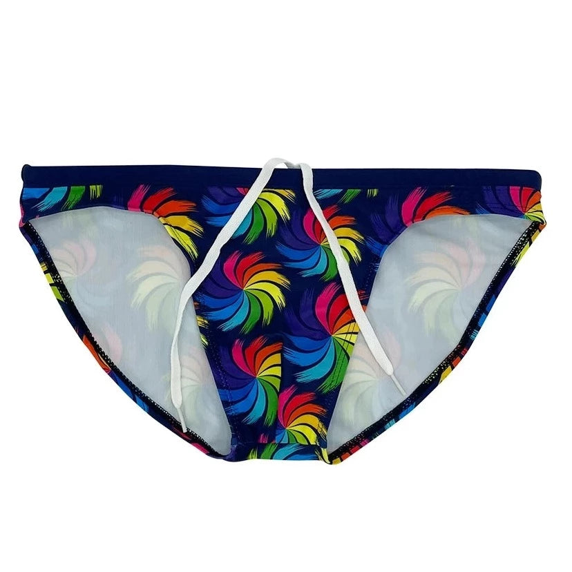 a hot gay man in Rainbow Whirlpool Skinny Swim Briefs - pridevoyageshop.com - gay men’s underwear and swimwear