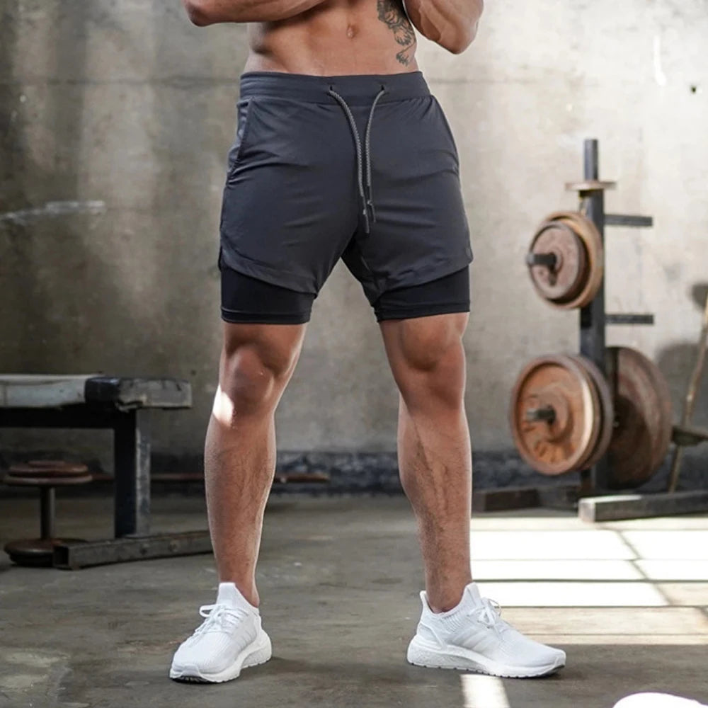 a muscle guy in gray Men's Double Layered Hidden Pocket Workout Shorts - pridevoyageshop.com - gay men’s underwear and swimwear