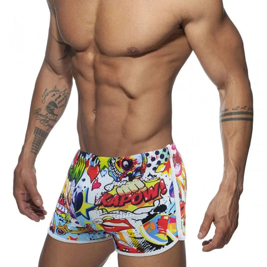 a hot gay man in Pop Art Plunge Swim Trunks - pridevoyageshop.com - gay men’s underwear and swimwear