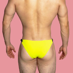 a sexy gay man in yellow VividFlash Leather Buckle Bikini Briefs - pridevoyageshop.com - gay men’s underwear and swimwear