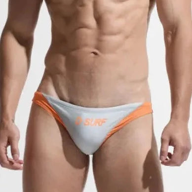 a sexy gay man in gray DESMIIT Men's D-Surf Swim Briefs - pridevoyageshop.com - gay men’s underwear and swimwear