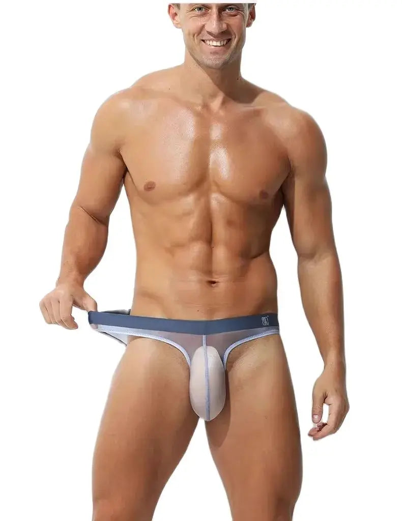 a sexy gay man in gray Transparent Hung Briefs - pridevoyageshop.com - gay men’s underwear and swimwear