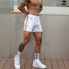 sexy gay man in white Rainbow Striped Gym Booty Shorts | Gay Shorts - Men's Activewear, gym short, sport shorts, running shorts- pridevoyageshop.com