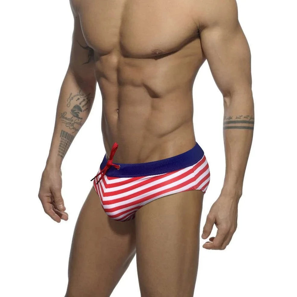 a hot gay man in red Sailor‘s Striped Bowtie Swim Briefs - pridevoyageshop.com - gay men’s underwear and swimwear