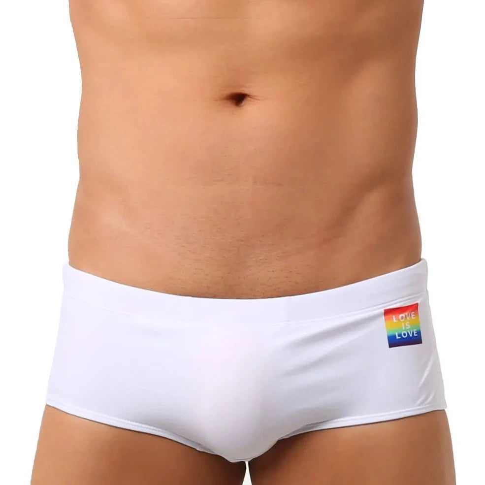 a hot gay in white Love Is Love Pride Swim Trunks - pridevoyageshop.com - gay men’s underwear and swimwear