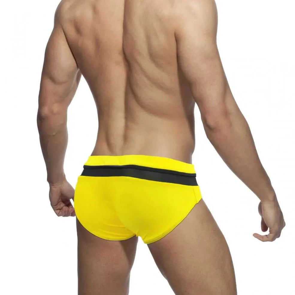 a sexy gay man in Yellow and Black Men's Bowtie Zippered Swim Briefs - pridevoyageshop.com - gay men’s underwear and swimwear