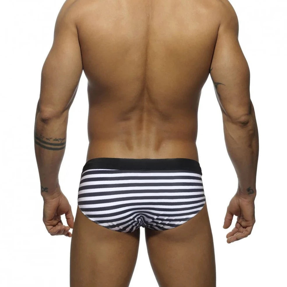 a hot gay man in black Sailor‘s Striped Bowtie Swim Briefs - pridevoyageshop.com - gay men’s underwear and swimwear