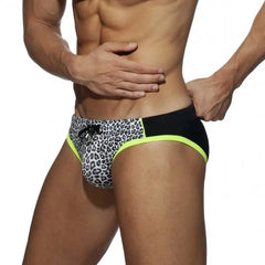 a sexy gay man in White Black DESMIIT Men's Leopard Print Bowtie Swim Briefs - pridevoyageshop.com - gay men’s underwear and swimwear