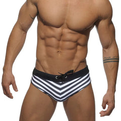a hot gay man in black Sailor‘s Striped Bowtie Swim Briefs - pridevoyageshop.com - gay men’s underwear and swimwear