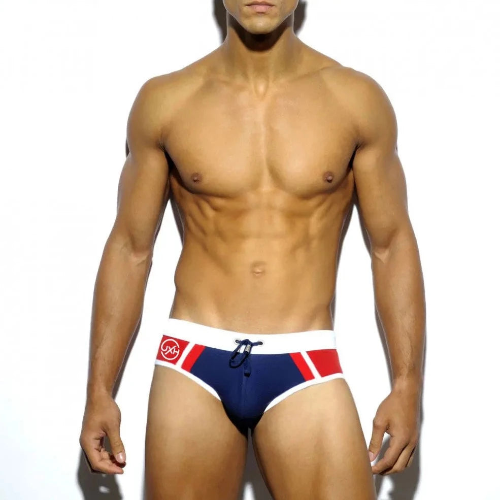 a hot gay man in dark blue Men's Two-toned Bold Swim Briefs - pridevoyageshop.com - gay men’s underwear and swimwear