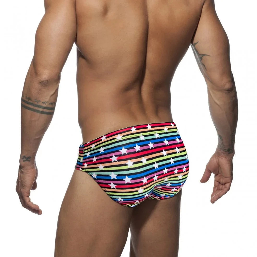 a hot gay man in Men's Rainbow Star Striped Swim Briefs - pridevoyageshop.com - gay men’s underwear and swimwear