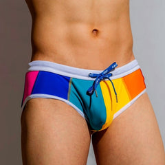 sexy gay man in Gay Swimwear | DM Rainbow Swim Briefs- pridevoyageshop.com - gay men’s underwear and swimwear