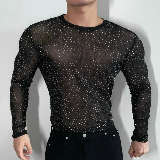 Twinkle Twunk Mesh Long Sleeve Black color sheer sparkle mesh long sleeve top worn by a muscular gay man posing in studio lighting pridevoyageshopcom gay mens gym tank tops mesh tank tops clubwear fashion tops and activewear