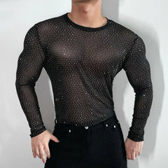 Twinkle Twunk Mesh Long Sleeve Black color sheer sparkle mesh long sleeve top worn by a muscular gay man posing in studio lighting pridevoyageshopcom gay mens gym tank tops mesh tank tops clubwear fashion tops and activewear