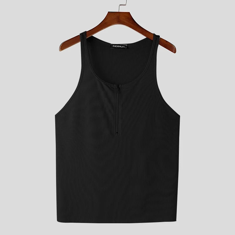 a flat lay of Black Men’s Gym Glow Ribbed Zip Tank - pridevoyageshop.com - gay men's fashion, clubwear, party outfit
