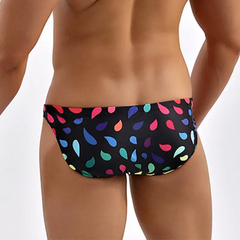 a hot man in Men’s Drippin’ Pride Swim Briefs - pridevoyageshop.com - gay men’s sexy swim briefs, trunks, board shorts, and bikinis