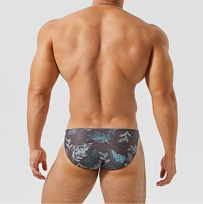 a sexy man inMen’s Midnight Jungle Jock Bikini Swim Briefs - pridevoyageshop.com - gay men’s sexy swim briefs, trunks, board shorts, and bikinis