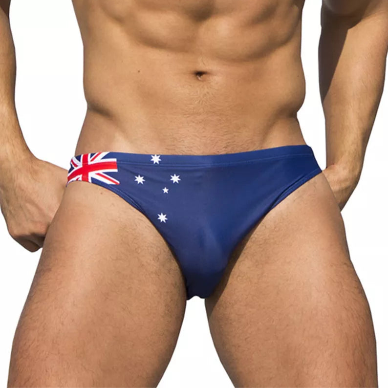 a sexy man in Australia Flag flag Men’s World Tour Bikini Swim Briefs - pridevoyageshop.com - gay men’s sexy swim briefs, trunks, board shorts, and bikinis