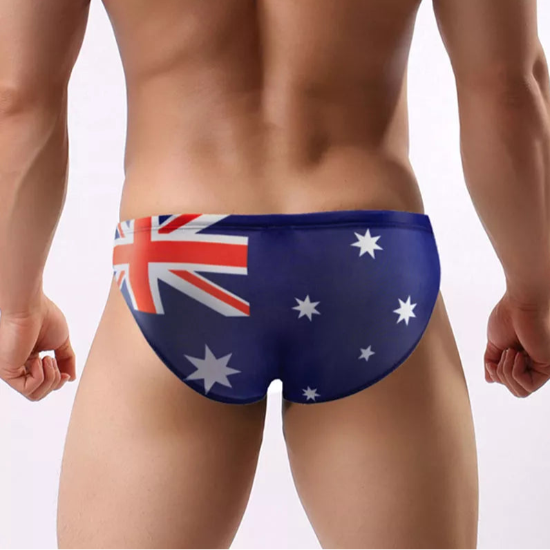 a sexy man in Australia Flag flag Men’s World Tour Bikini Swim Briefs - pridevoyageshop.com - gay men’s sexy swim briefs, trunks, board shorts, and bikinis