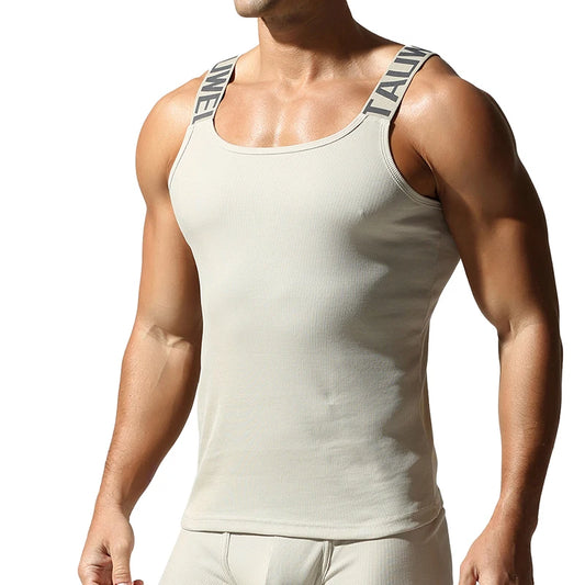 a sexy man in Beige White Muscle Mary Ribbed Strap Top - pridevoyageshop.com - gay men's fashion, clubwear, party outfit
