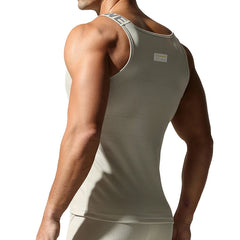 a sexy man in Beige White Muscle Mary Ribbed Strap Top - pridevoyageshop.com - gay men's fashion, clubwear, party outfit
