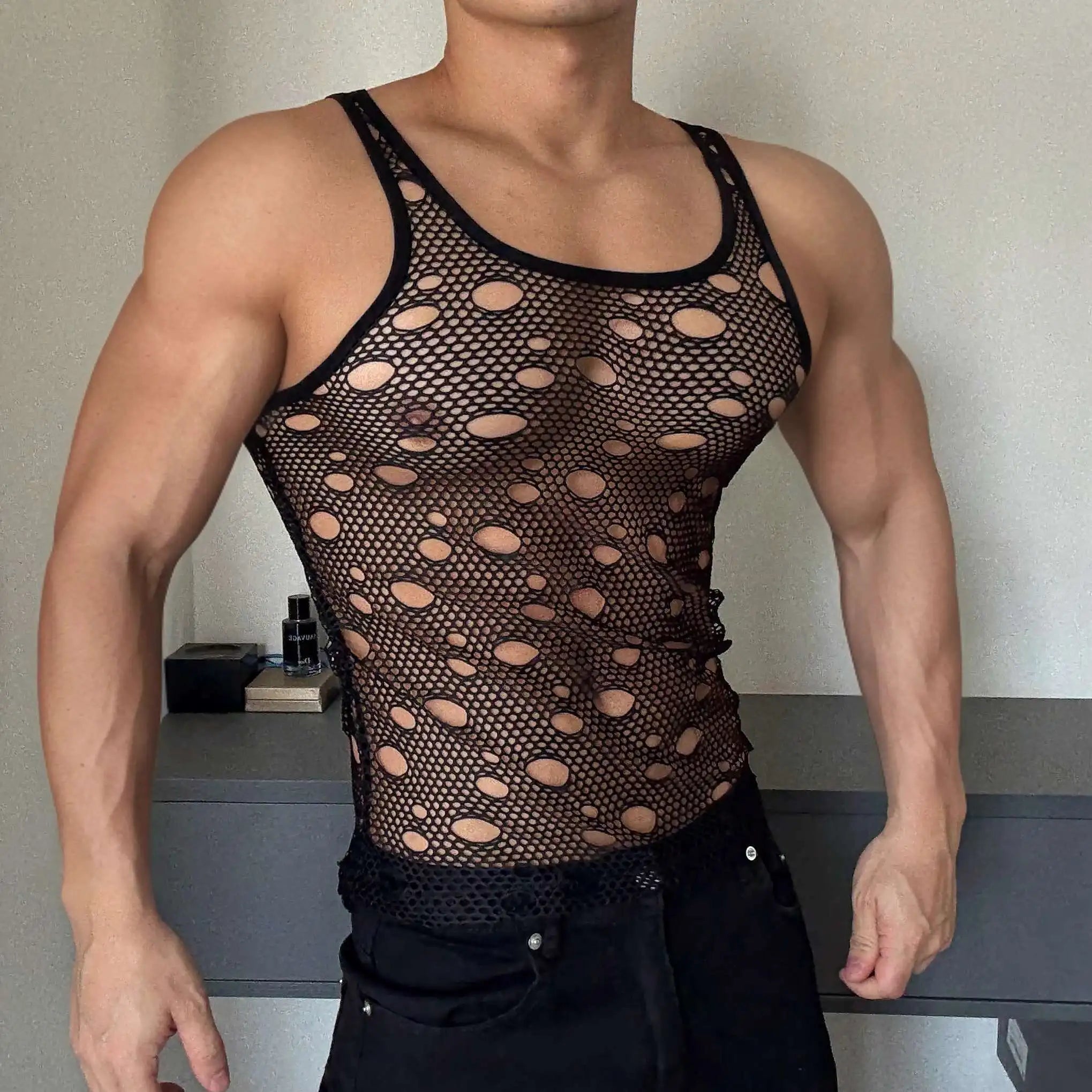 a sexy man in Black Go-Go Holey Cut-Out Mesh Top - pridevoyageshop.com - gay men's fashion, clubwear, party outfit
