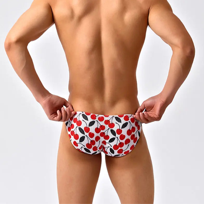 a sexy man in Cherry Tease Men’s Red Light Marina Mesh Bikini Swim Briefs - pridevoyageshop.com - gay men’s sexy swim briefs, trunks, board shorts, and bikinis