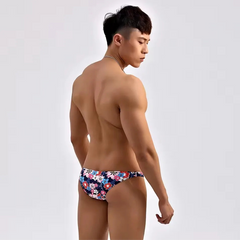 a sexy man in Dark Floral Men’s Summer Bloom Swim Bikini Briefs - pridevoyageshop.com - gay men’s sexy swim briefs, trunks, board shorts, and bikinis