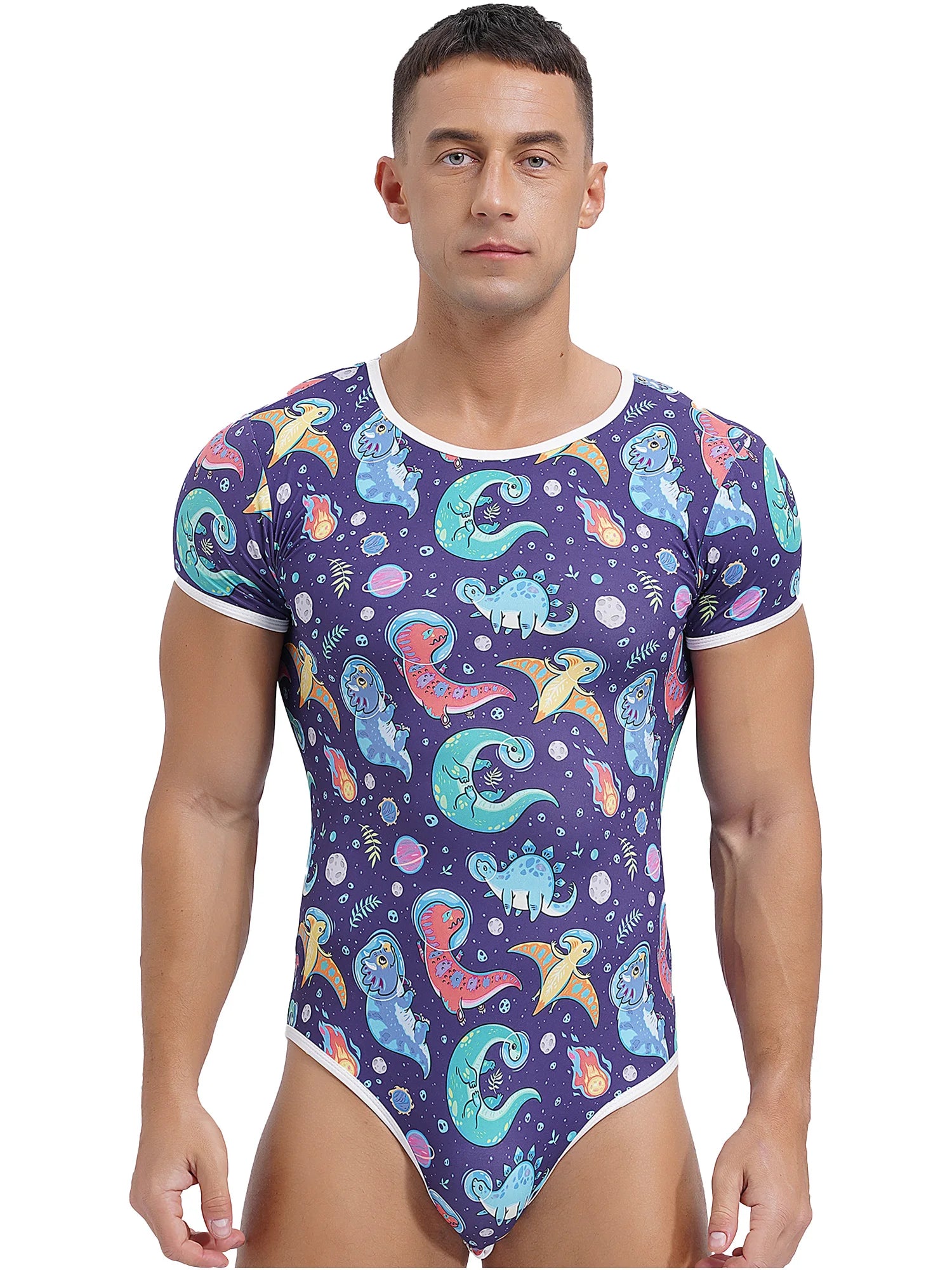 a sexy man in Gaylaxy Dinos Daddy’s Boy Printed Onesie, playful fit, body-hugging cartoon print, showing cheeky youthful vibe – pridevoyageshop.com – gay men’s harness, lingerie and fetish wear