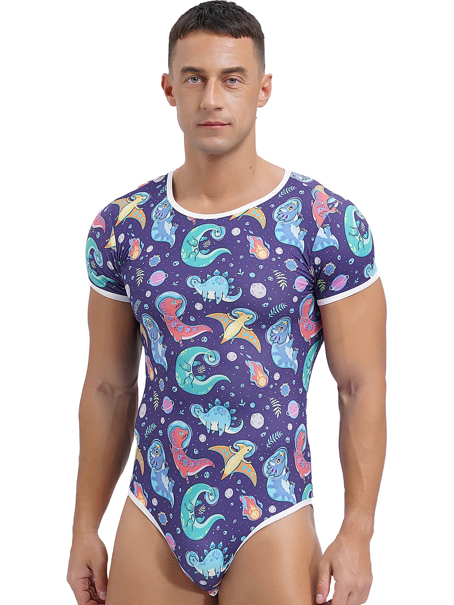 a sexy man in Gaylaxy Dinos Daddy’s Boy Printed Onesie, playful fit, body-hugging cartoon print, showing cheeky youthful vibe – pridevoyageshop.com – gay men’s harness, lingerie and fetish wear