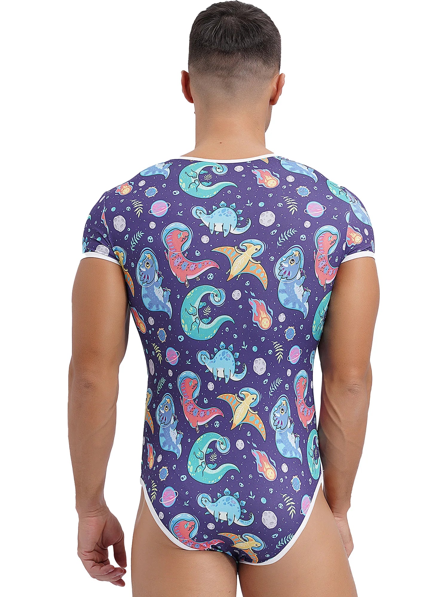 a sexy man in Gaylaxy Dinos Daddy’s Boy Printed Onesie, playful fit, body-hugging cartoon print, showing cheeky youthful vibe – pridevoyageshop.com – gay men’s harness, lingerie and fetish wear