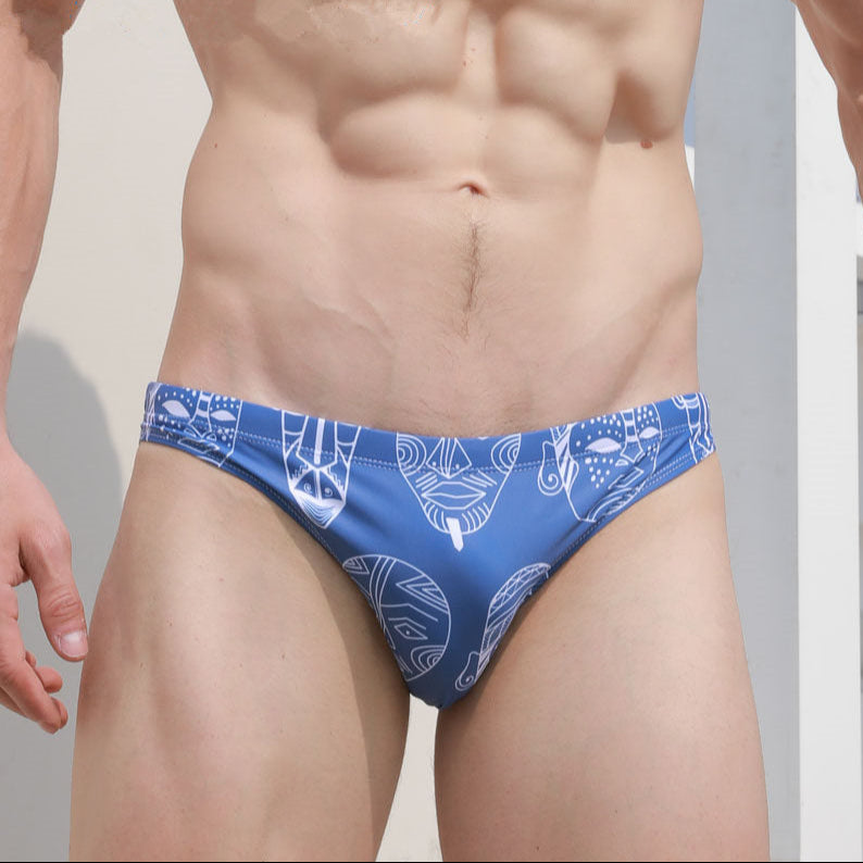 a sexy man in Indigo Totem Men’s Poolside Rites Swim Briefs - pridevoyageshop.com - gay men’s sexy swim briefs, trunks, board shorts, and bikinis