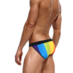 a sexy man in Men’s Pride Rainbow Stripes Swim Briefs with Pad - pridevoyageshop.com - gay men’s sexy swim briefs, trunks, board shorts, and bikinis