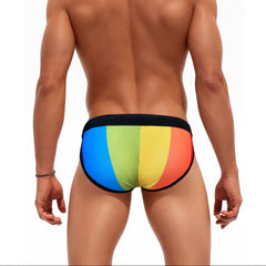 a sexy man in Men’s Pride Rainbow Stripes Swim Briefs with Pad - pridevoyageshop.com - gay men’s sexy swim briefs, trunks, board shorts, and bikinis