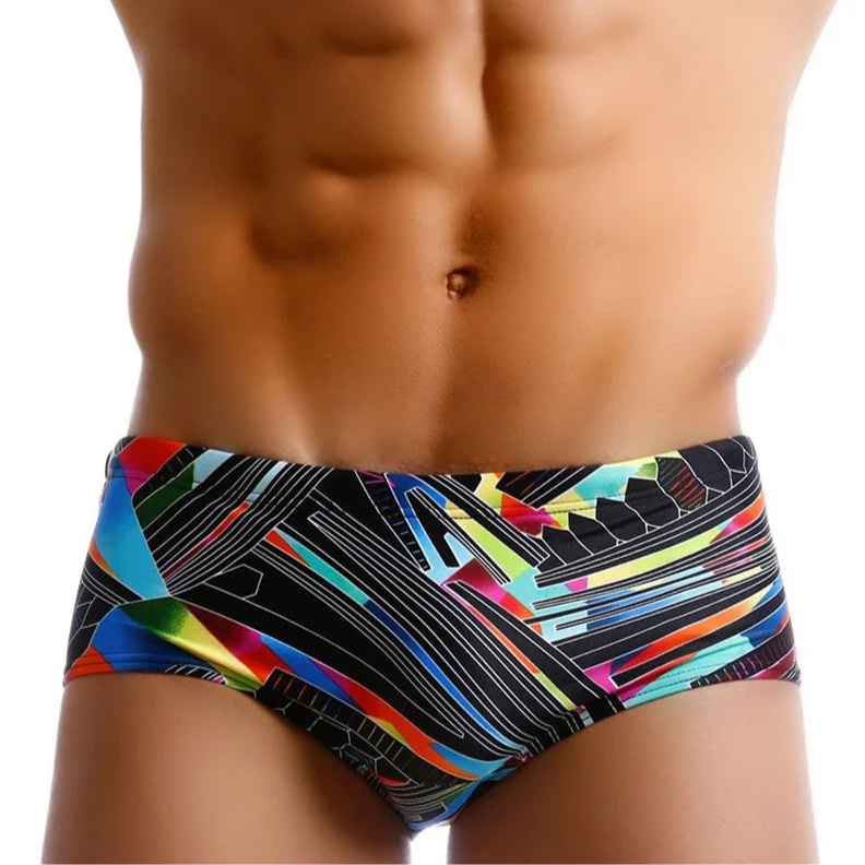a sexy man in Men’s Pride Voltage Low Rise Swim Trunks with pad – pridevoyageshop.com – gay men’s sexy swim briefs, trunks, board shorts, and bikinis