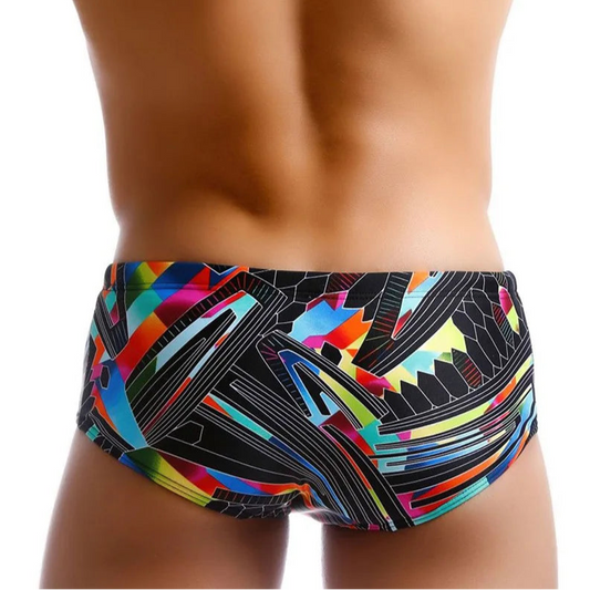 a sexy man in Men’s Pride Voltage Low Rise Swim Trunks with pad – pridevoyageshop.com – gay men’s sexy swim briefs, trunks, board shorts, and bikinis