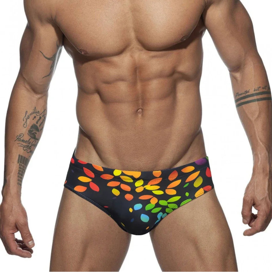 a sexy man in Men’s Rainbow Leafs Swim Briefs - pridevoyageshop.com - gay men’s sexy swim briefs, trunks, board shorts, and bikinis