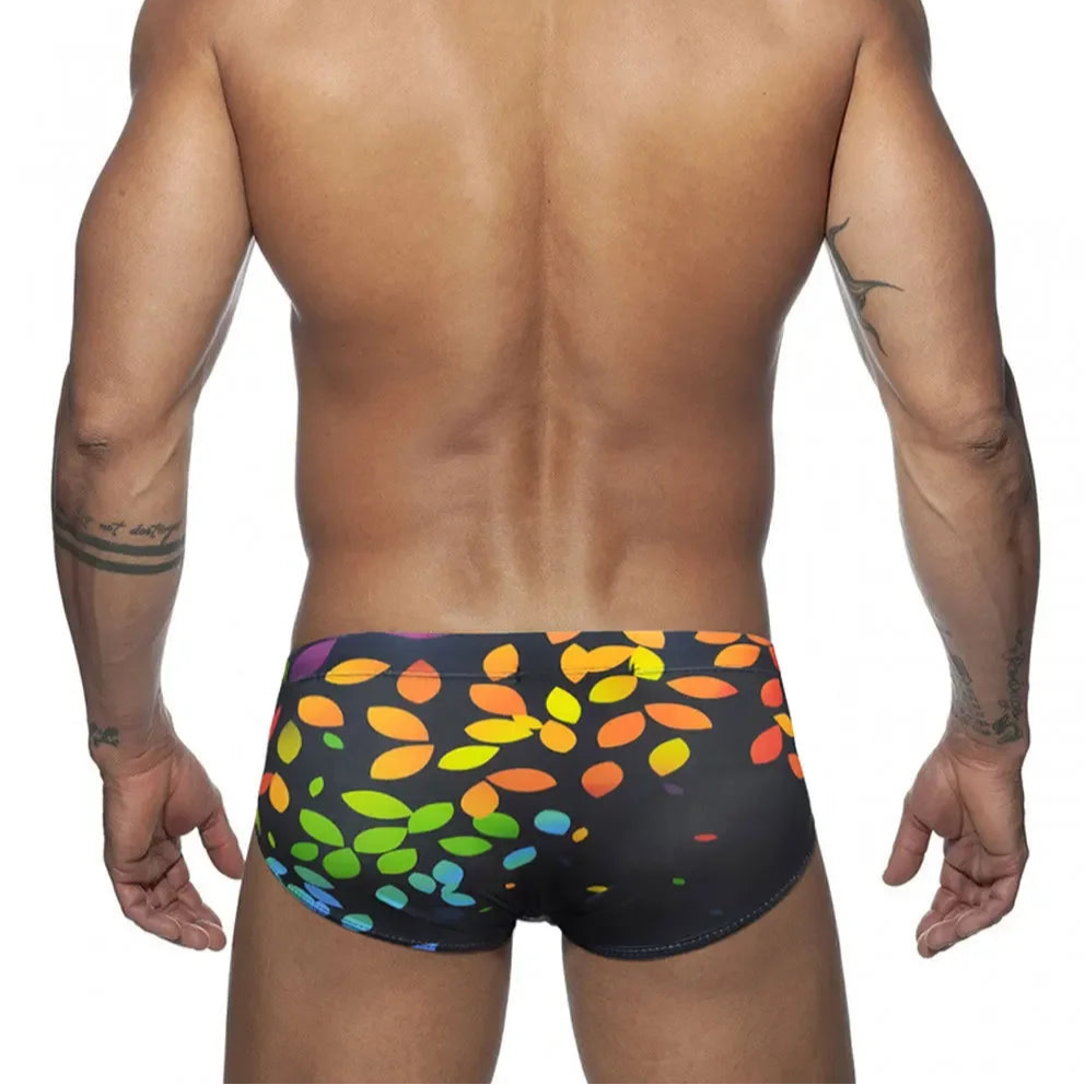 a sexy man in Men’s Rainbow Leafs Swim Briefs - pridevoyageshop.com - gay men’s sexy swim briefs, trunks, board shorts, and bikinis