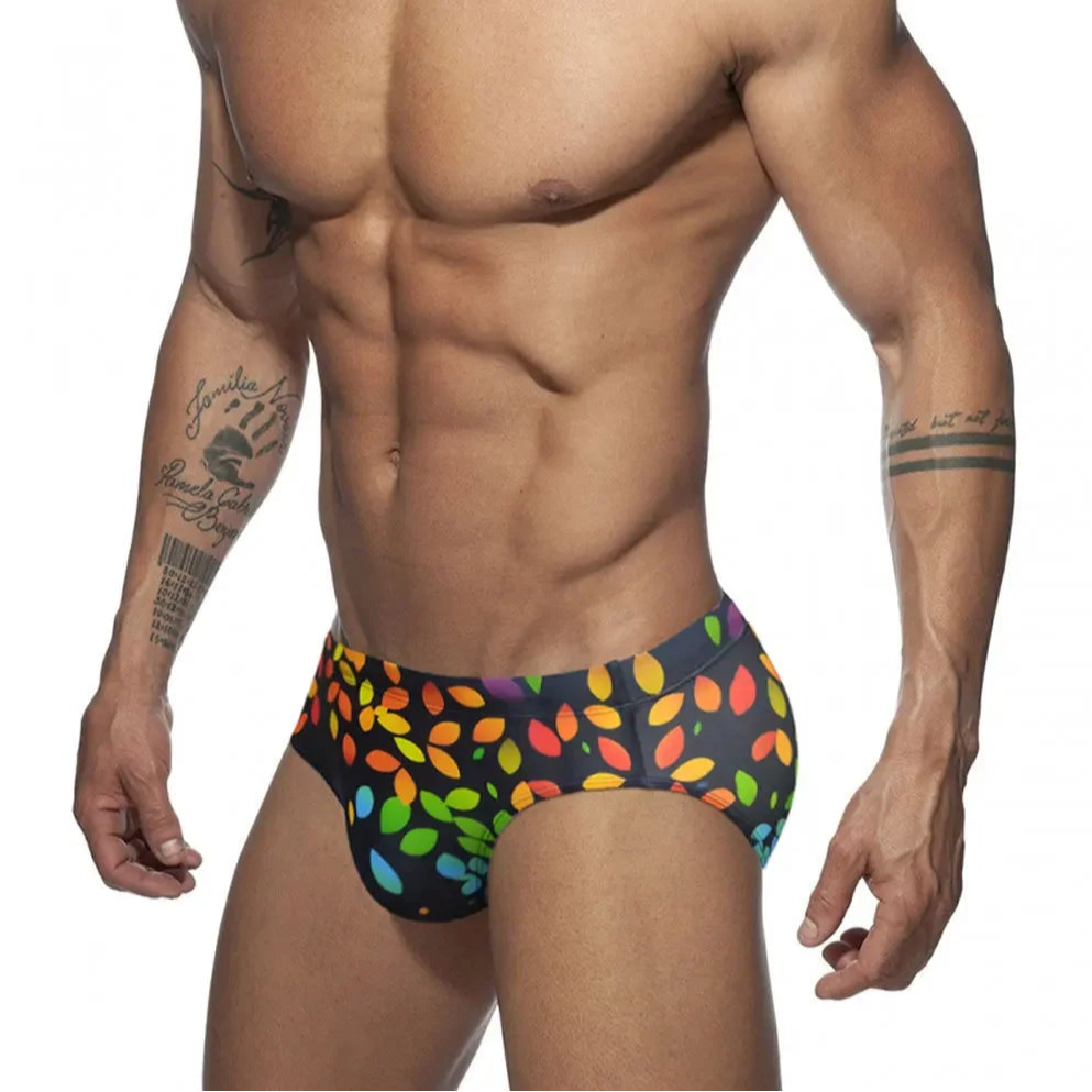 a sexy man in Men’s Rainbow Leafs Swim Briefs - pridevoyageshop.com - gay men’s sexy swim briefs, trunks, board shorts, and bikinis