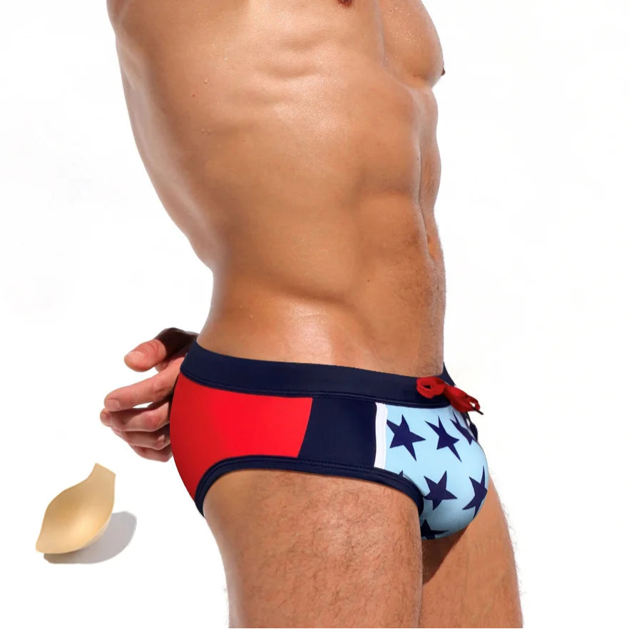 a sexy man in Men’s Star-Spangled Swim Briefs with pad - pridevoyageshop.com - gay men’s sexy swim briefs, trunks, board shorts, and bikinis