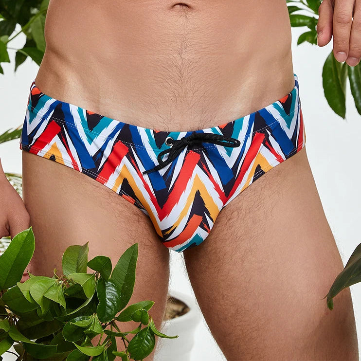 a sexy man in Men’s Zigzag Zaddy Swim Briefs - pridevoyageshop.com - gay men’s sexy swim briefs, trunks, board shorts, and bikinis