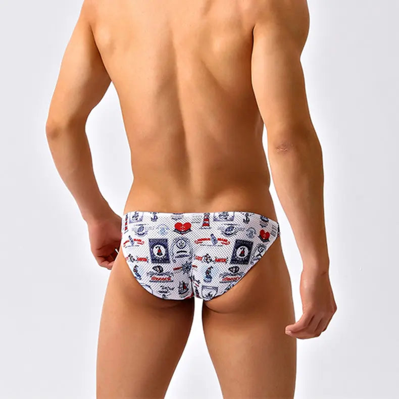 a sexy man in Nautical Play Men’s Red Light Marina Mesh Bikini Swim Briefs - pridevoyageshop.com - gay men’s sexy swim briefs, trunks, board shorts, and bikinis