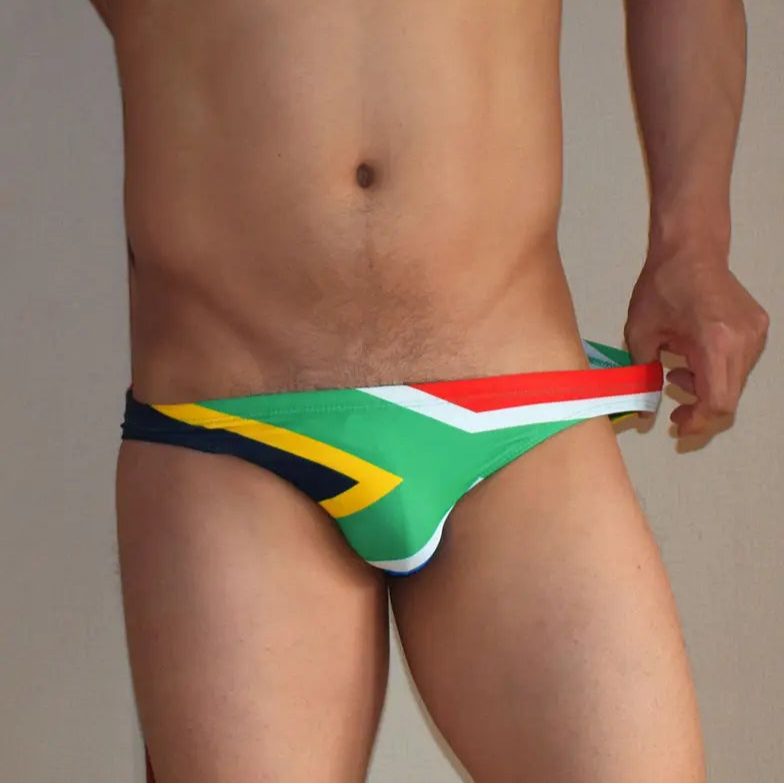 a sexy man in South Africa Flag flag Men’s World Tour Bikini Swim Briefs - pridevoyageshop.com - gay men’s sexy swim briefs, trunks, board shorts, and bikinis