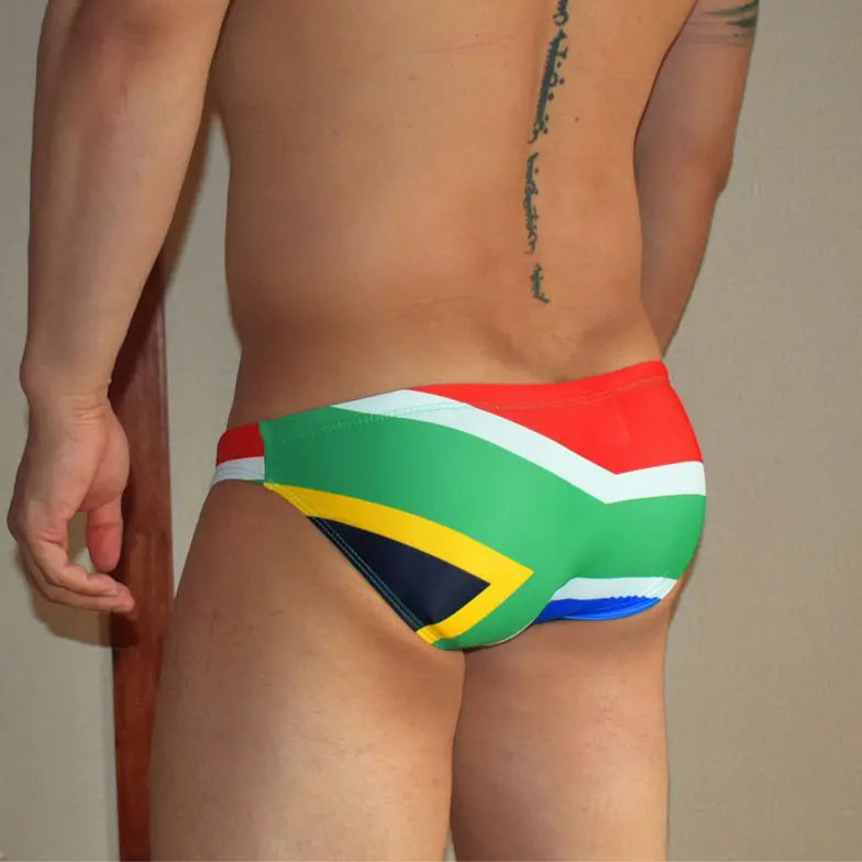 a sexy man in South Africa Flag flag Men’s World Tour Bikini Swim Briefs - pridevoyageshop.com - gay men’s sexy swim briefs, trunks, board shorts, and bikinis