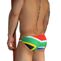 a sexy man in South Africa flag Men’s Flag Frenzy Swim Briefs - pridevoyageshop.com - gay men’s sexy swim briefs, trunks, board shorts, and bikinis
