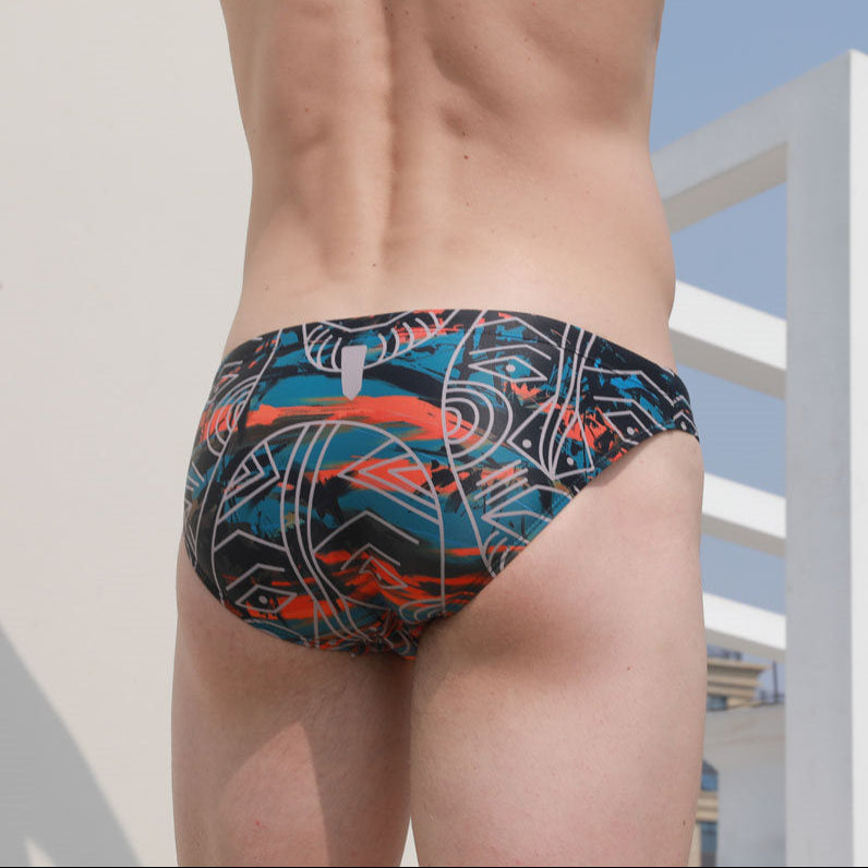 a sexy man in Tribal Flame Men’s Poolside Rites Swim Briefs - pridevoyageshop.com - gay men’s sexy swim briefs, trunks, board shorts, and bikinis
