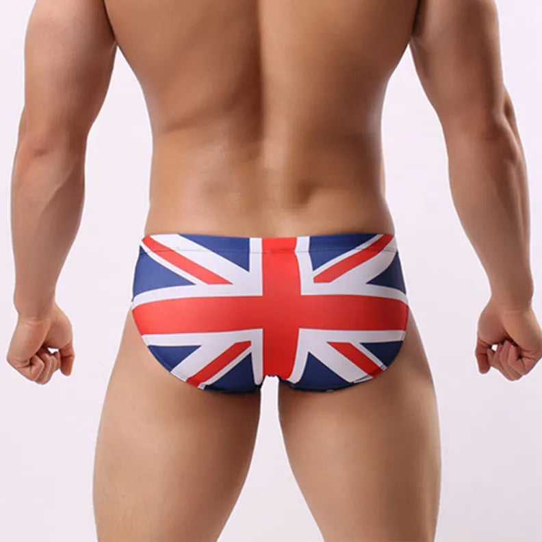 a sexy man in UK flag Men’s Flagged & Fitted Low Rise Swim Briefs - pridevoyageshop.com - gay men’s sexy swim briefs, trunks, board shorts, and bikinis