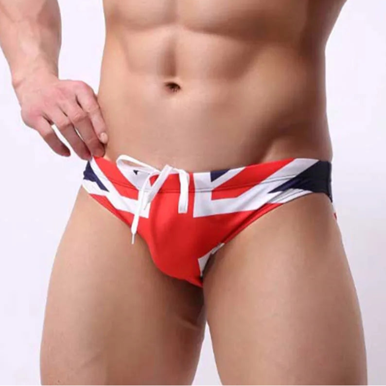 a sexy man in UK flag Men’s World Tour Bikini Swim Briefs - pridevoyageshop.com - gay men’s sexy swim briefs, trunks, board shorts, and bikinis