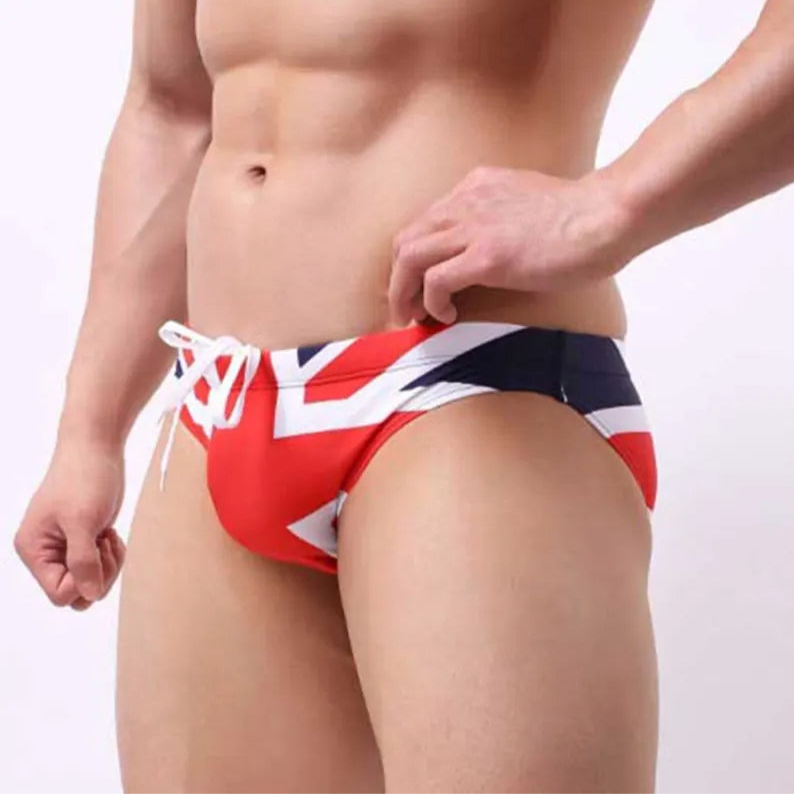 a sexy man in UK flag Men’s World Tour Bikini Swim Briefs - pridevoyageshop.com - gay men’s sexy swim briefs, trunks, board shorts, and bikinis